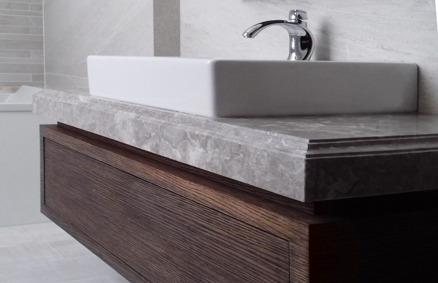 Custom bathroom vanity with countertop and vessel sink.